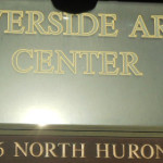 Riverside Arts Center in gold on a window
