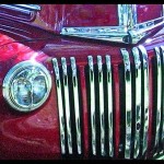 Shiny pink vintage car and front grill work